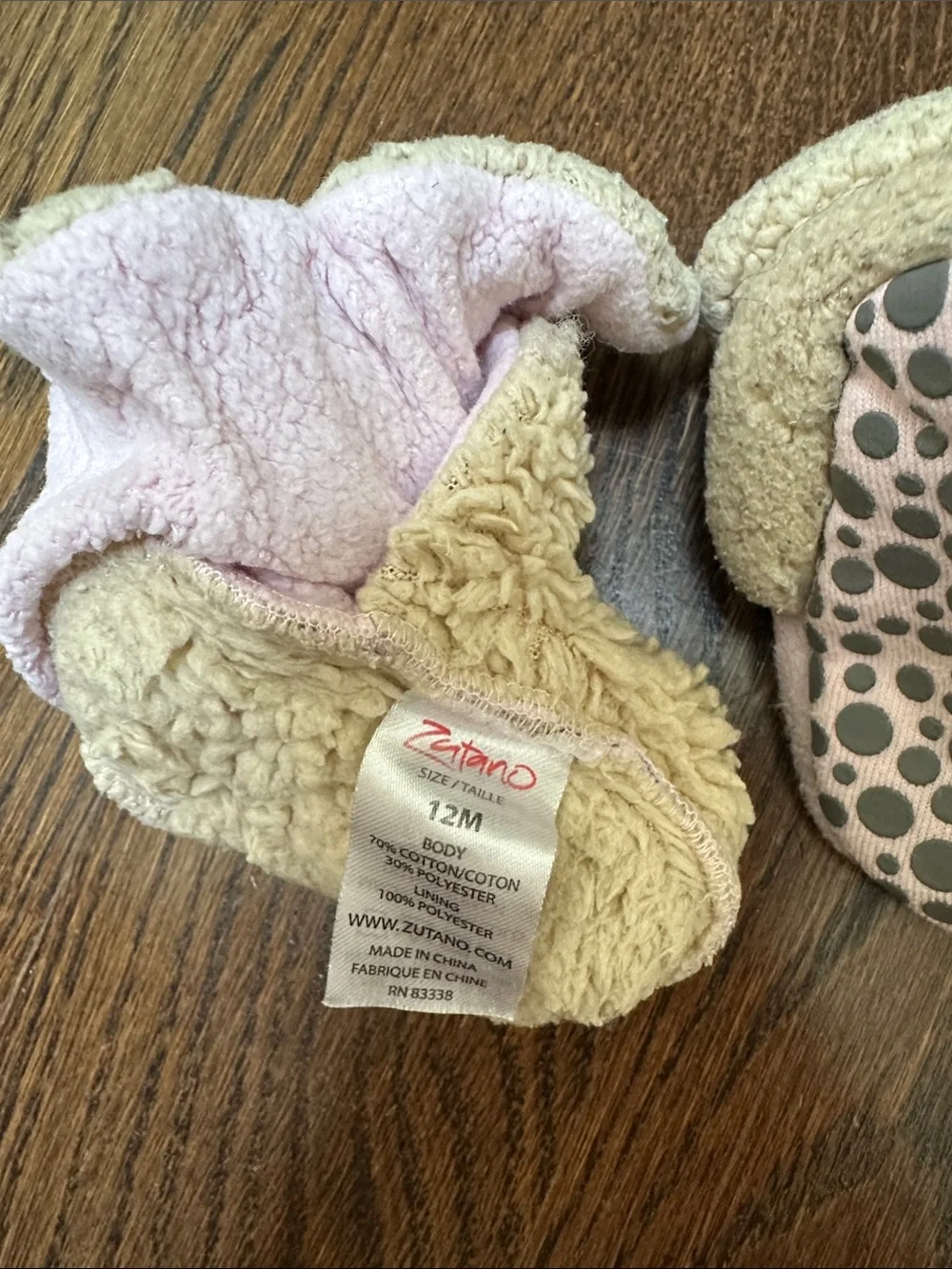 Two pairs of baby Zutano booties, 12M